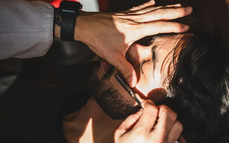 Shaping a beard using a cut-throat razor